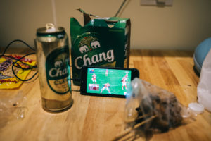 what does a sports addict do when in other side of the world? yes, stream the game on the phone... and drink.